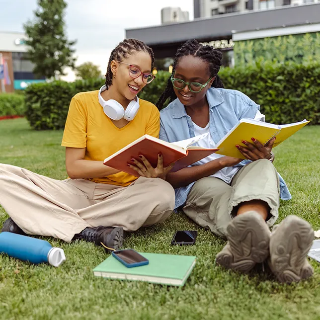 two young college students comparing notes